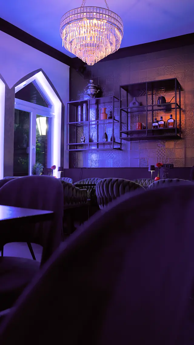 Lounge der Tap Bar mit Kronleuchter und violettem Licht